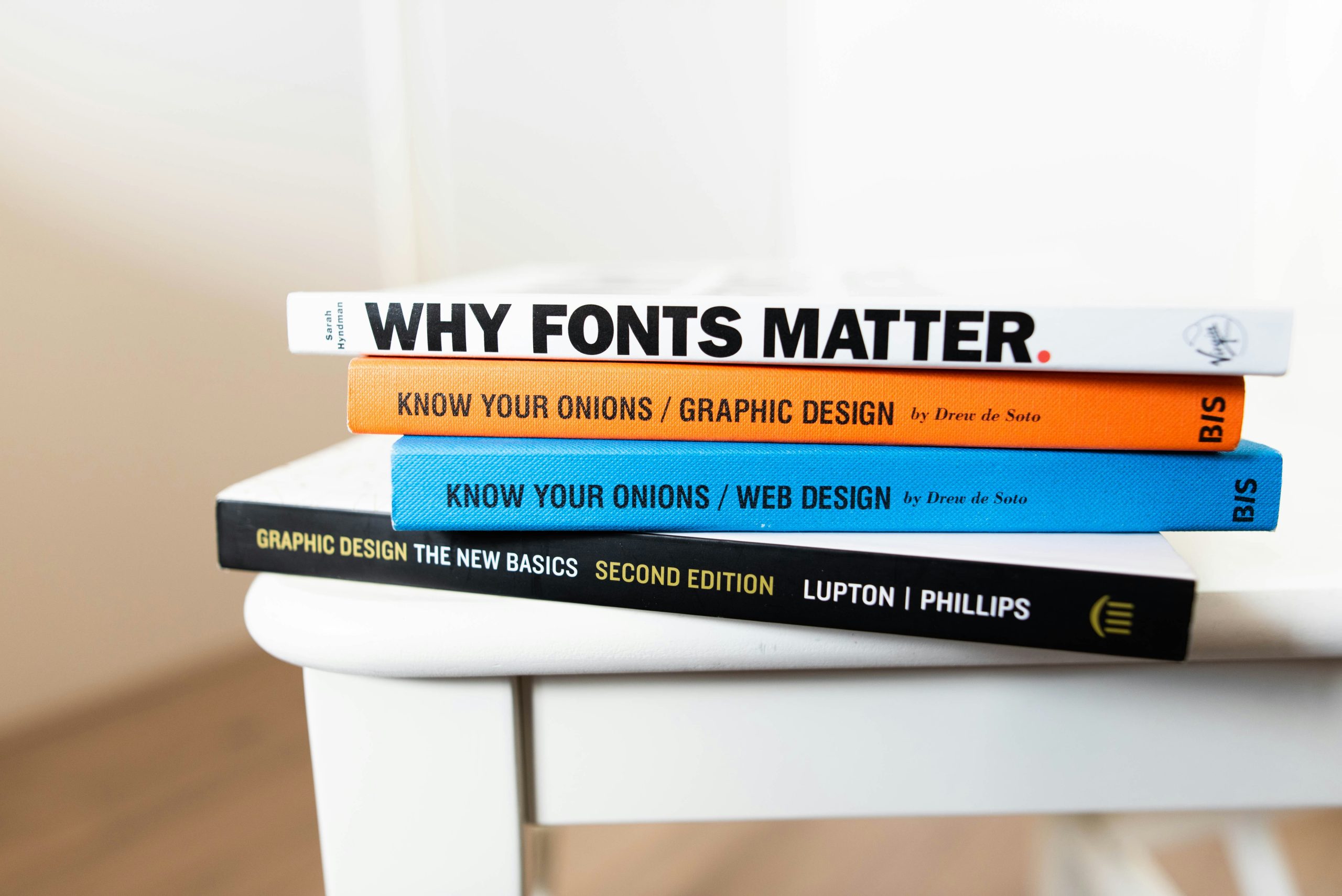 An image of books about graphic design stacked on top of each other..